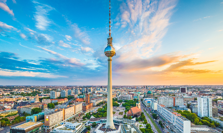 Aerial view of Berlin skyline with famous TV tower at Alexanderplatz and dramatic cloudscape at sunset, Germany