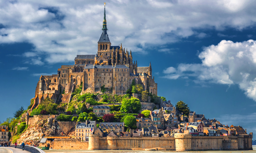 Beautiful panoramic view of famous Le Mont Saint-Michel tidal island with blue sky