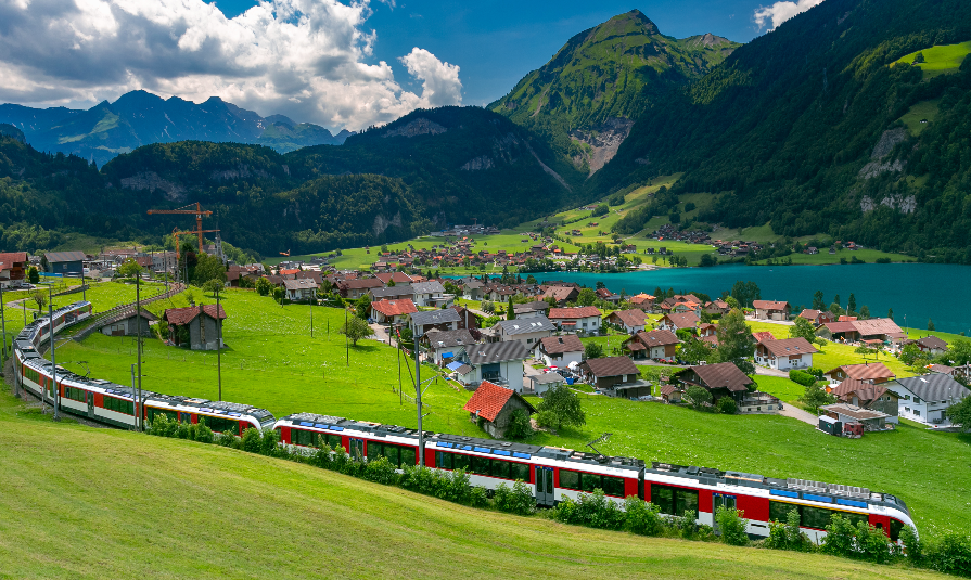 Famous electric red tourist panoramic train in swiss village Lungern