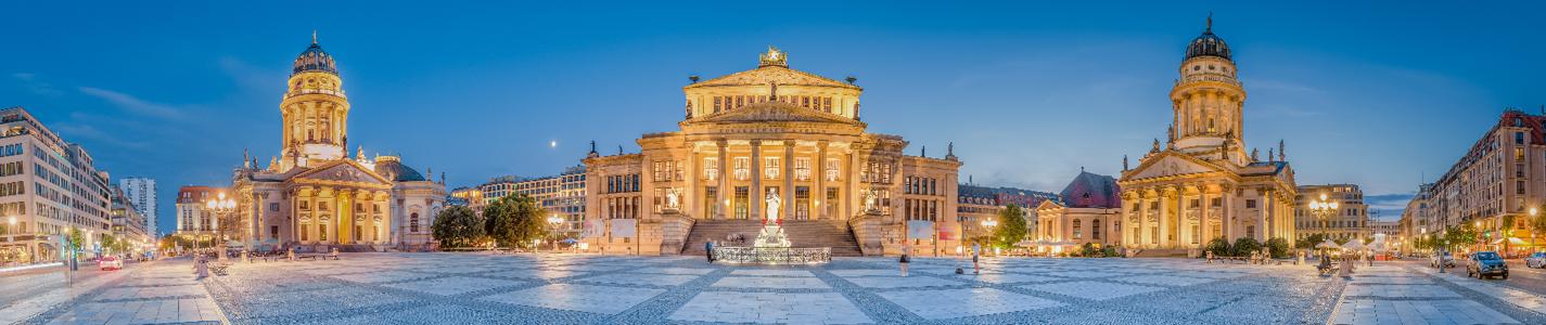 Classic panoramic view of famous Gendarmenmarkt square with historic Berlin Concert Hall and German and French Churches in twilight at dusk, Berlin, Germany