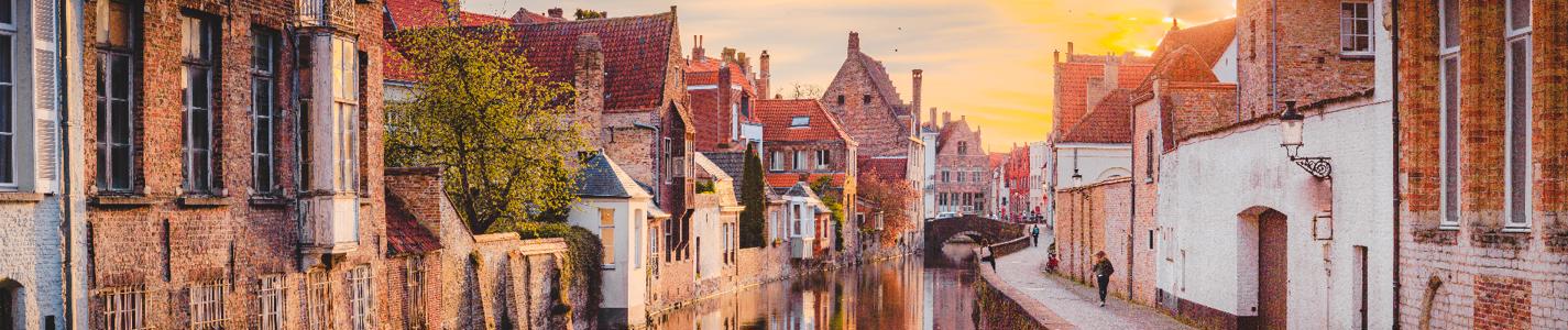 Panoramic view of the historic city center of Brugge in beautiful golden morning light at sunrise, province of West Flanders, Belgium