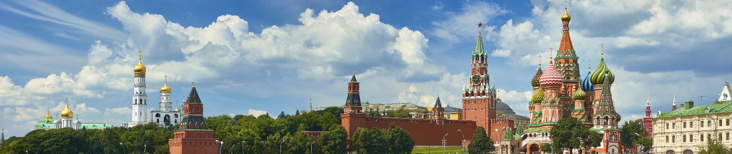 Panoramic view on Moscow Red Square, Kremlin towers, stars and Clock Kuranti, Saint Basil's Cathedral church Ivan bell tower. Panorama from hotel Russia. Moscow holidays vacation tours Putin residence