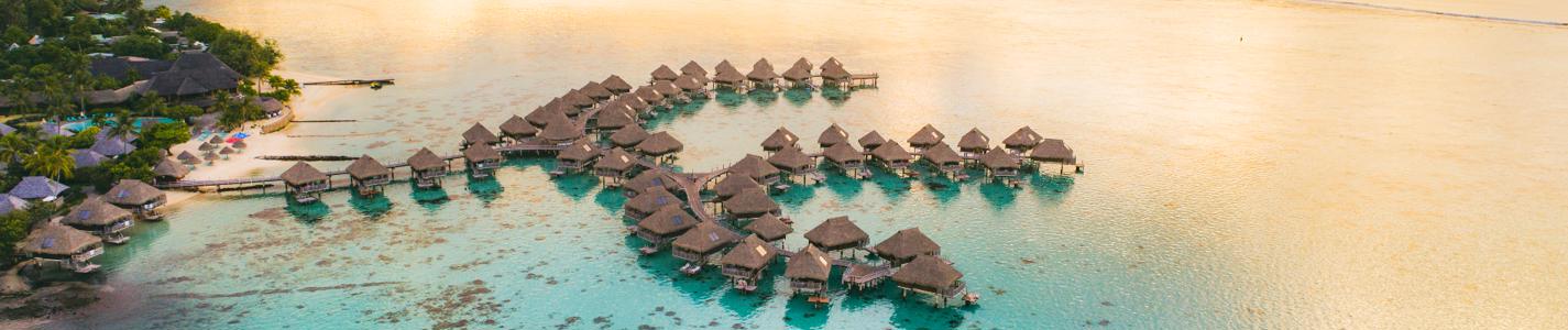 Romantic honeymoon getaway in overwater bungalows villas of Tahiti resort, Bora Bora, French Polynesia.