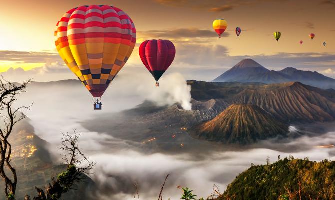 Colorful hot air balloons flying over Mount Bromo