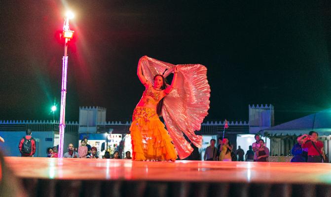 Belly dancer doing her performance in desert safari camp, Dubai, UAE.