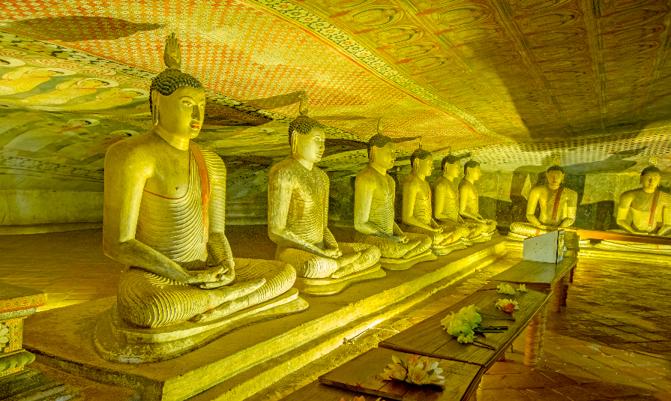 DAMBULLA, SRI LANKA –  Dambulla cave golden temple & statues o in Dambulla, Sri Lanka. Dambulla cave temple is the largest and best preserved cave temple complex in Sri Lanka 