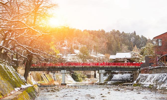Red Nakabashi bridge the entrance to historic old town, a tourist destination in city of Hida Takayama in Gifu Prefecture, Japan at sunrise.