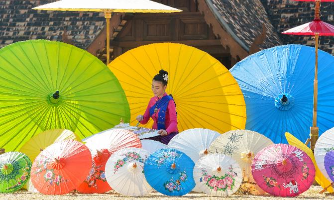 The Woman In Traditional Costume painting umbrella,chiangmai Thailand