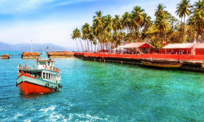 Tourist boat near Ross island beach Andaman India with scenic landscape