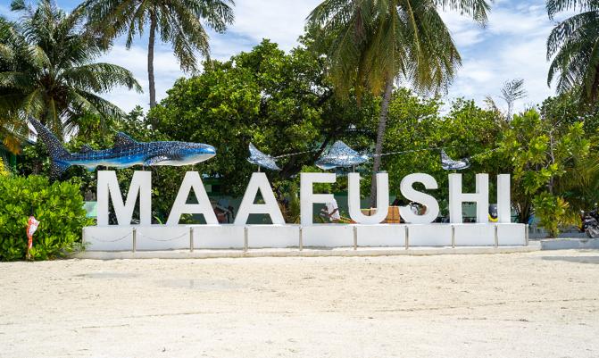  Welcome sign for the island of Maafushi, a tourist and local island with hotels, resorts and shops.